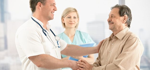 Doctor shaking hands with senior patient